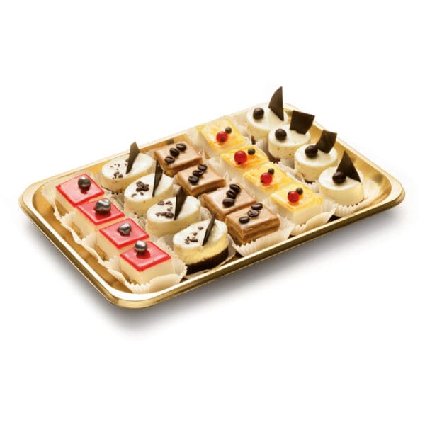 An assortment of mini desserts, showcasing red, white, and brown pastries adorned with chocolate pieces, cream, and fruit garnishes is elegantly arranged in rows on an Alcas Pastry Take Out Tray "Kado" Gold measuring 13.58" x 10.04".