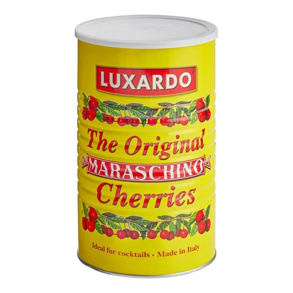 A tall yellow can from the Luxardo Gourmet Maraschino Cherries in Syrup collection, featuring bold red and white text. The label includes cherry illustrations and proudly states "The Original Maraschino Cherries," with a note at the bottom reading "Ideal for cocktails - Made in Italy.