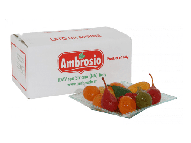 A case labeled "Ambrosio Candied Pears for Preparation of Desserts (1x5Kg case)" is placed next to a clear glass plate displaying vibrant, candy-shaped fruits that evoke the essence of preserved candied fruit. The packaging prominently highlights its Italian heritage, featuring fruits in deep shades of red, orange, yellow, and green.