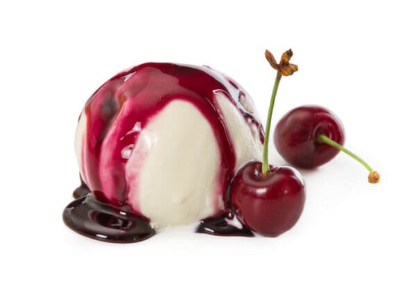 A scoop of vanilla ice cream drizzled with cherry syrup and accompanied by two Luxardo Gourmet Maraschino Cherries in Syrup (from a 4x5.6Kg case), set against a white background.