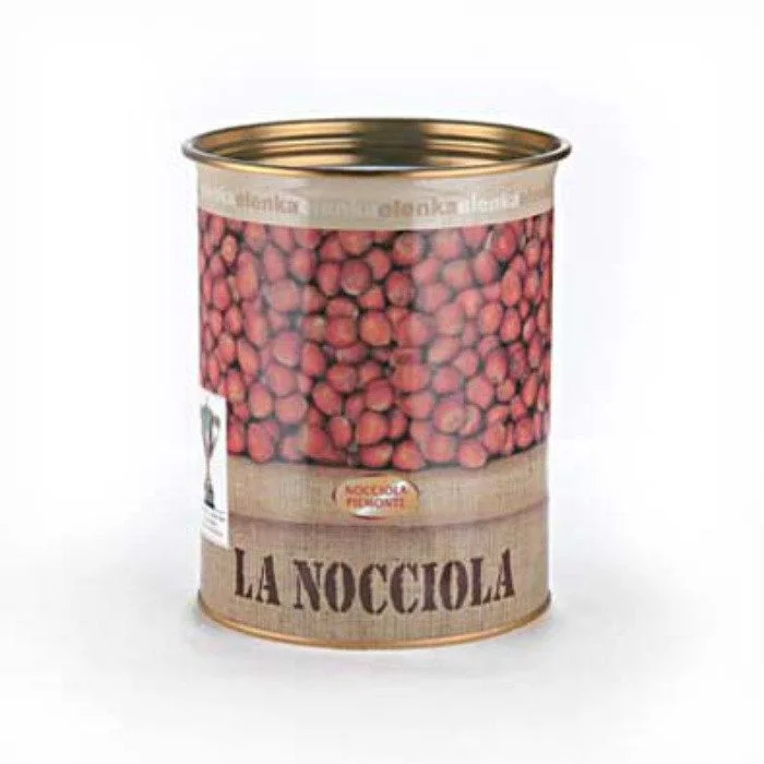 The "LA NOCCIOLA" tin can, featuring a hazelnut image and a textured upper label, captivates with its rich essence similar to Elenka Hazelnut Paste Nocciola "Laurus," offered in a 2x5.5Kg case.