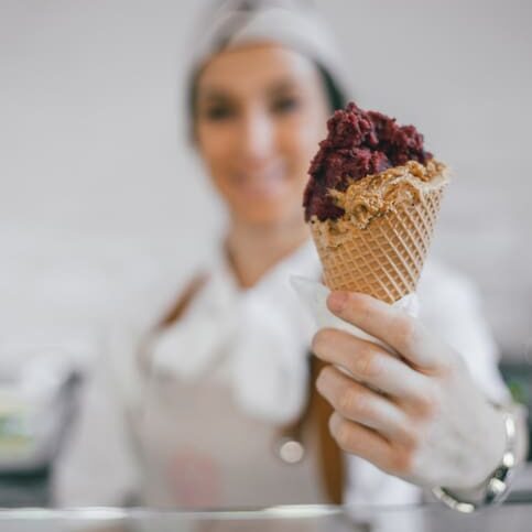 Woman giving customer an ice cream